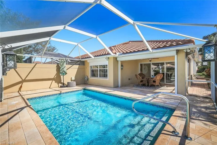 Outdoor pool featuring a sunroom, a patio area, a lanai, and outdoor dining area