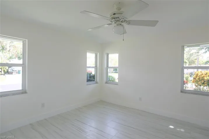 Unfurnished room with ceiling fan and a wealth of natural light