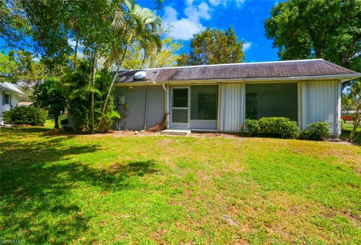 Rear view of property featuring a lawn