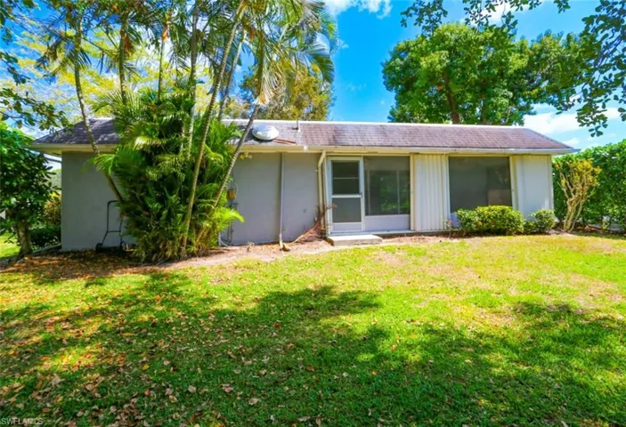 Back of property featuring a lawn