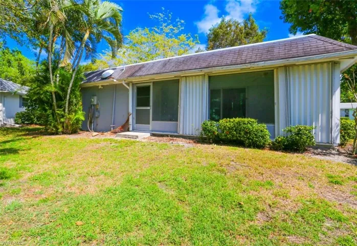 Back of house with a lawn