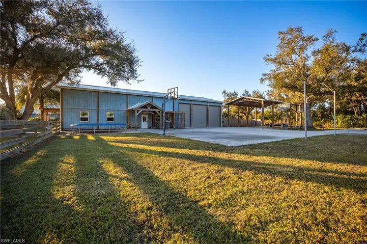 View of front of house with a front lawn and a carport