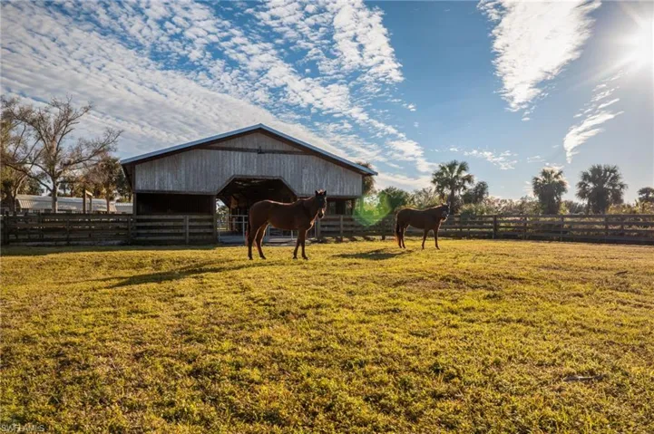 View of stable featuring a rural view