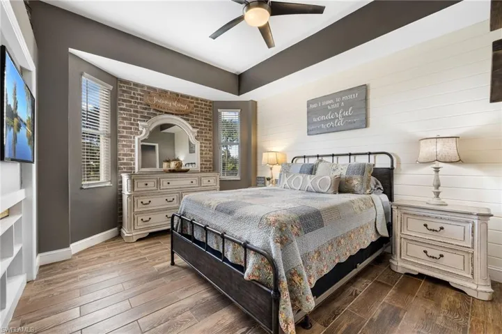 Bedroom featuring dark hardwood / wood-style floors and ceiling fan