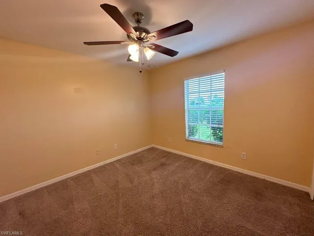 Bedroom 2 room with ceiling fan and carpet