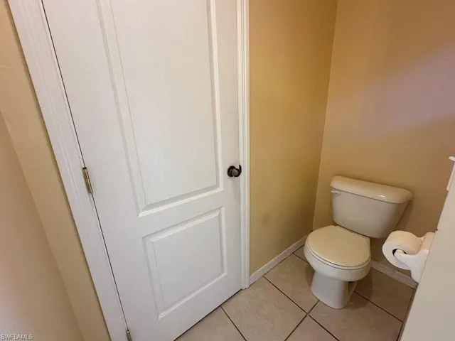 Bathroom with toilet and tile patterned flooring