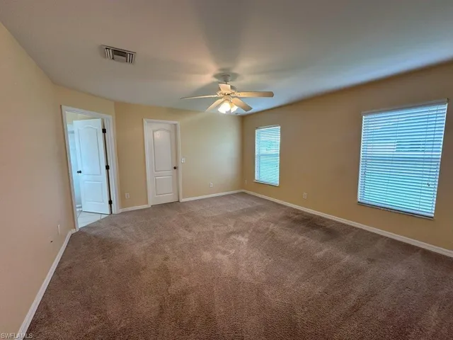 Carpeted Bedroom featuring ceiling fan