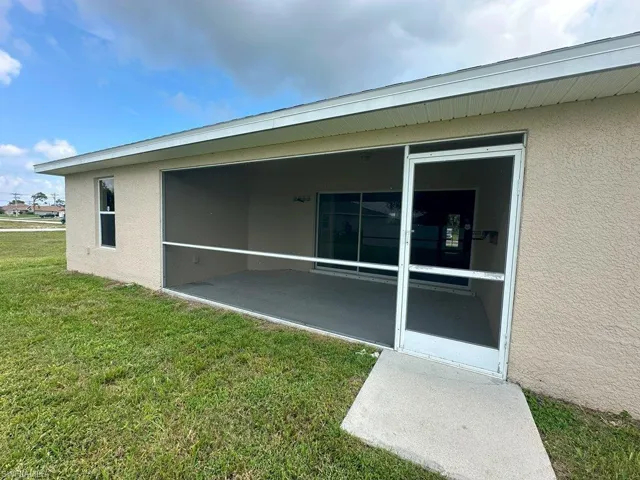 View of property exterior with a yard