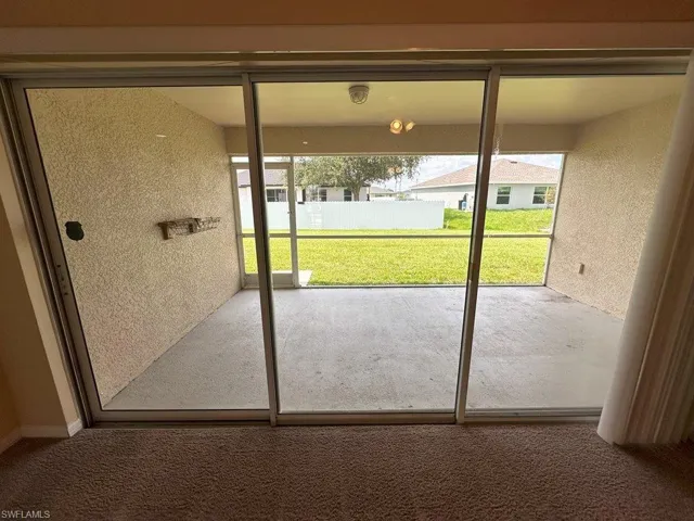 Entryway with plenty of natural light and carpet floors