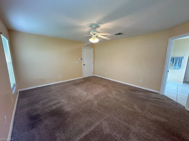 Carpeted Bedroom featuring ceiling fan