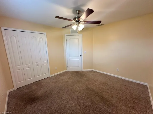 Bedroom 2 with carpet flooring, a closet, and ceiling fan