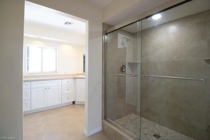 Full bath with vanity and a stall shower