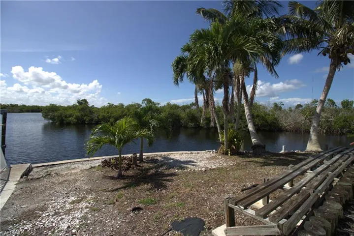 Dock area featuring boat lift and a water view
