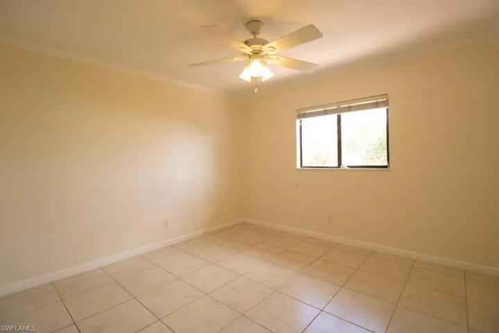Washroom featuring cabinet space, light tile patterned flooring, and independent washer and dryer