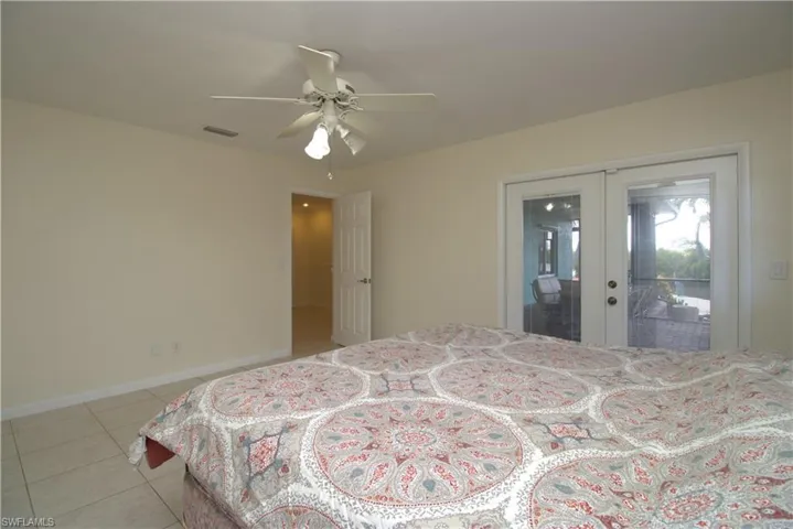 Bedroom featuring light tile patterned floors and ceiling fan
