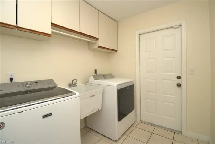 Unfurnished bedroom with ornamental molding, tile patterned floors, ceiling fan, and a closet