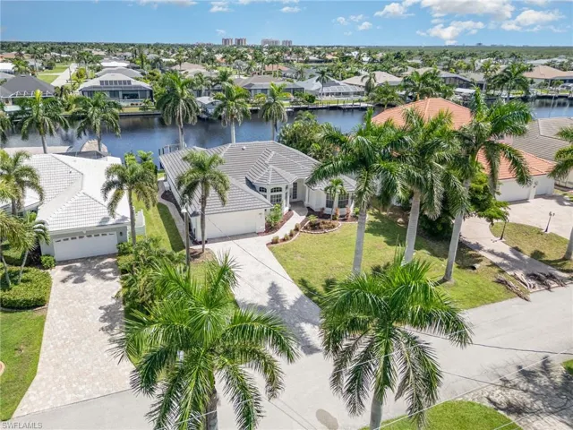 Aerial perspective of suburban area featuring a nearby body of water
