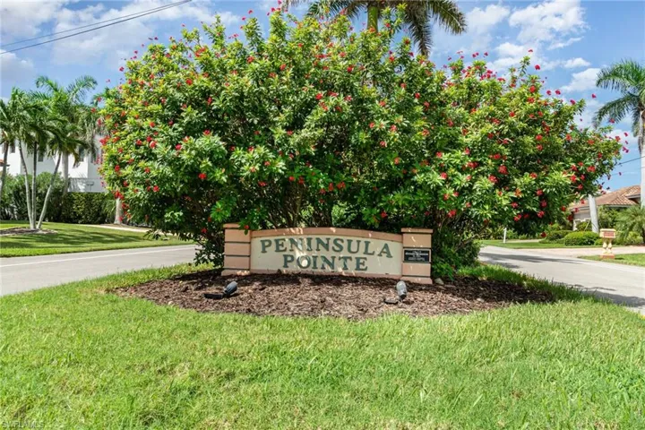 Community / neighborhood sign featuring a lawn