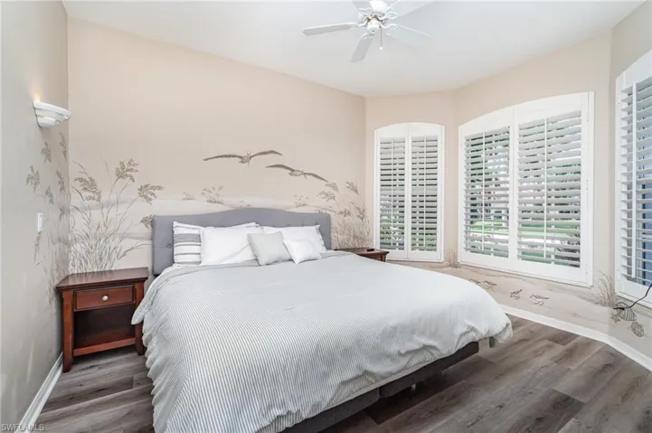 Bedroom with wood finished floors and a ceiling fan