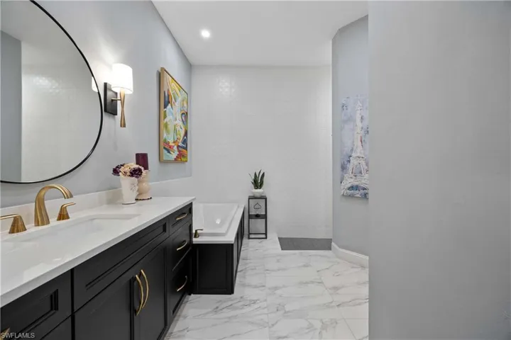 Bathroom with vanity and a tile shower