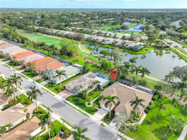 Birds eye view of property with a water view