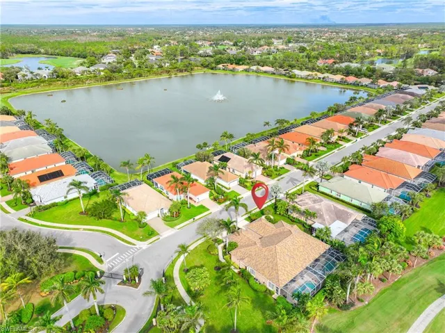 Birds eye view of property with a water view