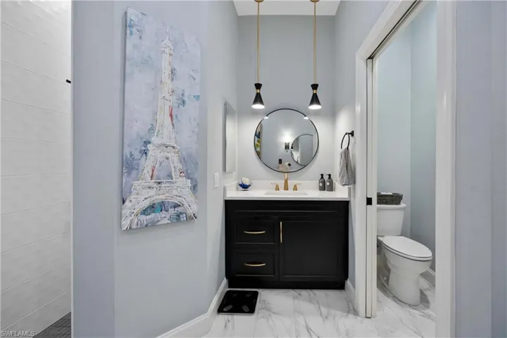 Bathroom featuring vanity and toilet