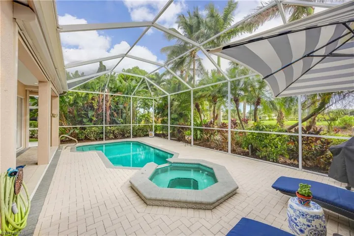 View of pool with a lanai, a patio area, and an in ground hot tub