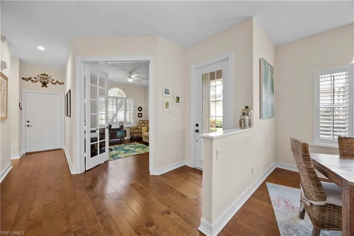 Foyer with ceiling fan and dark hardwood / wood-style floors