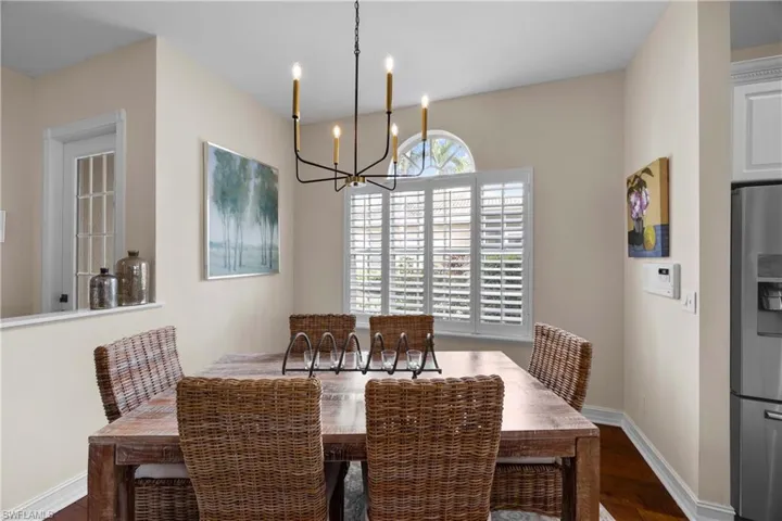 Dining area featuring dark hardwood / wood-style floors and an inviting chandelier