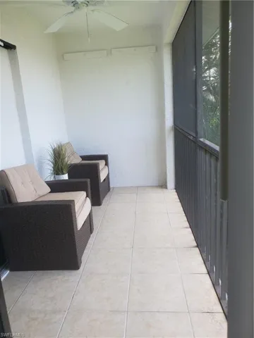 Screened balcony featuring ceiling fan