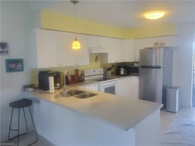 Whirlpool stove and stainless steel refrigerator