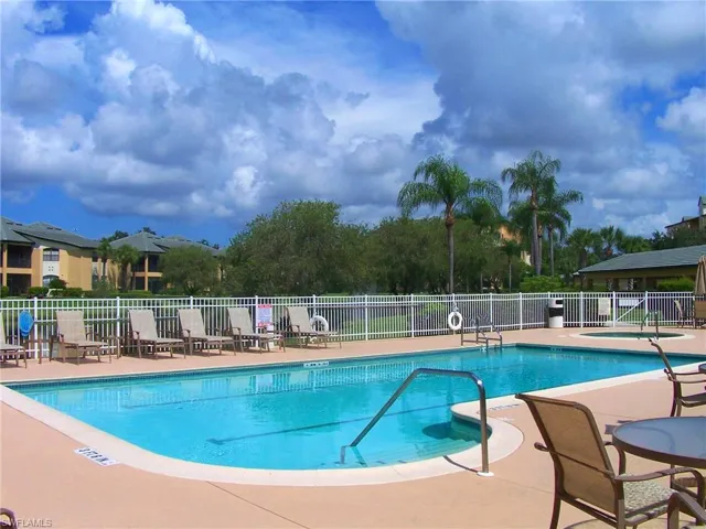Community pool featuring a patio area and a community hot tub