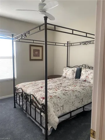 Bedroom with ceiling fan and carpet flooring