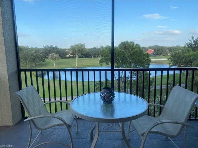 Balcony with a sunroom and a water view