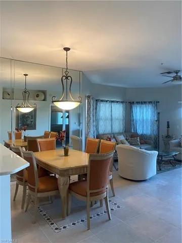 Dining room with light tile patterned flooring and a ceiling fan