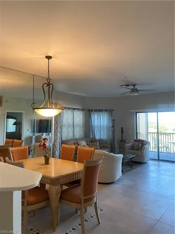 Dining room featuring ceiling fan and light tile patterned floors