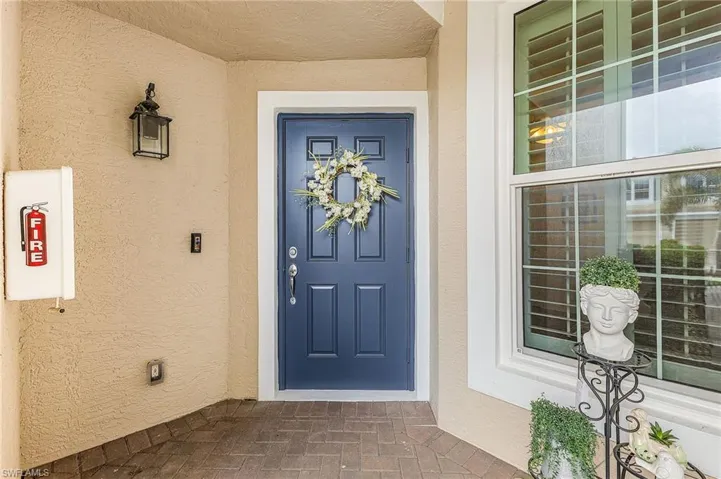 Property entrance featuring stucco siding
