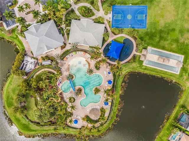 Drone / aerial view of a nearby body of water and a pool
