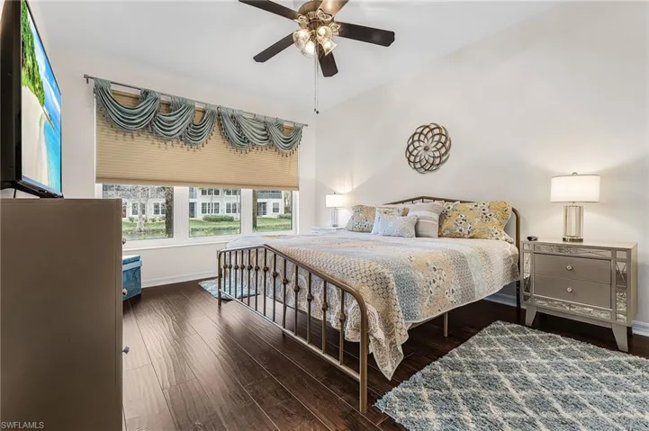 Bedroom with dark wood-type flooring and ceiling fan