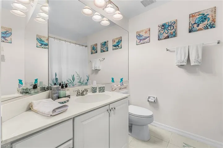 Bathroom featuring vanity, a shower with curtain, and light tile patterned floors