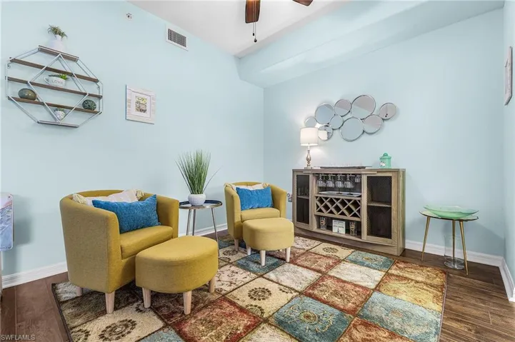 Sitting room with wood finished floors and ceiling fan
