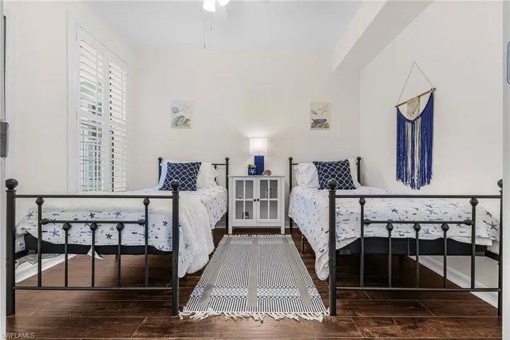 Bedroom featuring dark wood finished floors and ceiling fan