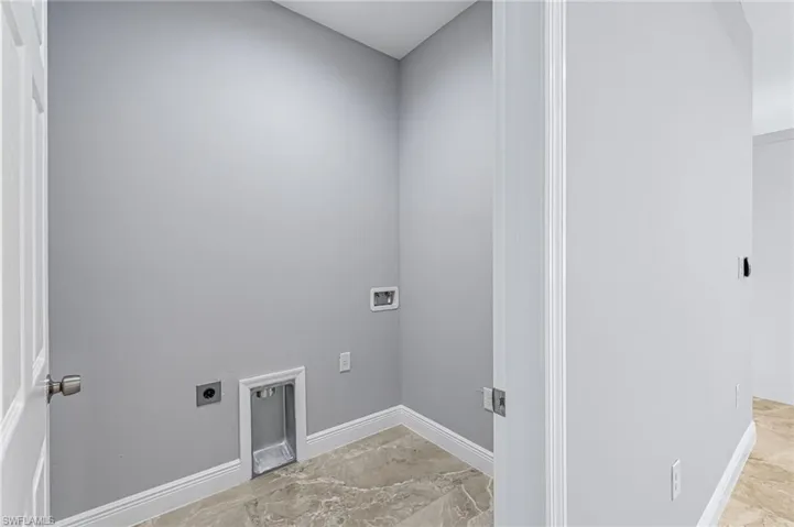 Laundry room with electric dryer hookup, light tile floors, and hookup for a washing machine