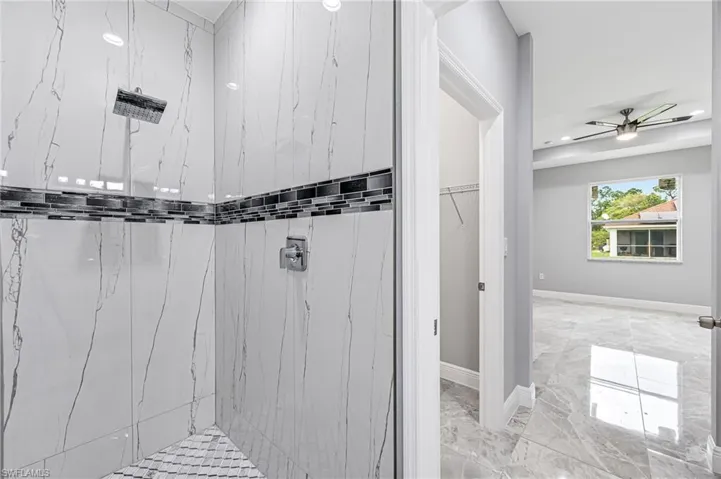 Bathroom featuring tile flooring and ceiling fan