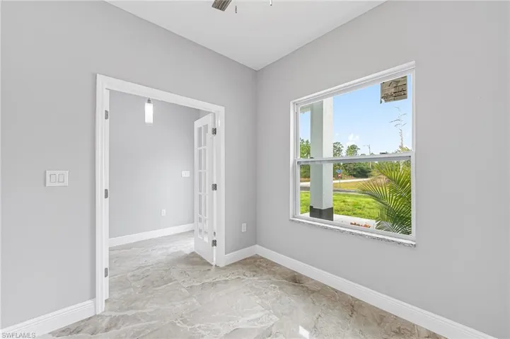 Unfurnished room featuring light tile flooring