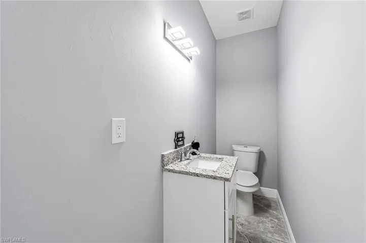 Bathroom with tile floors, vanity, and toilet