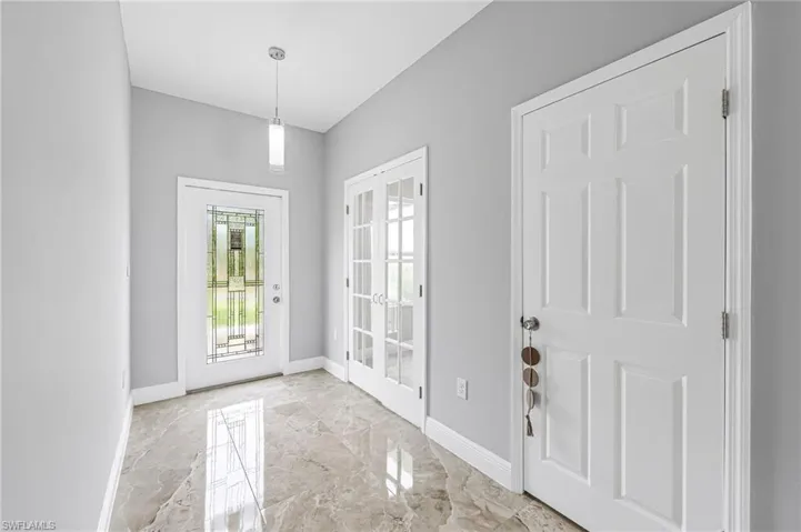 Doorway featuring french doors and light tile floors