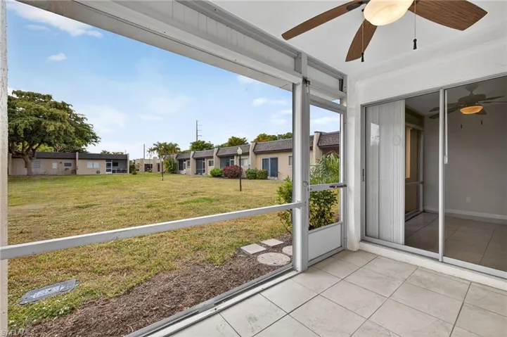 Unfurnished sunroom featuring a ceiling fan