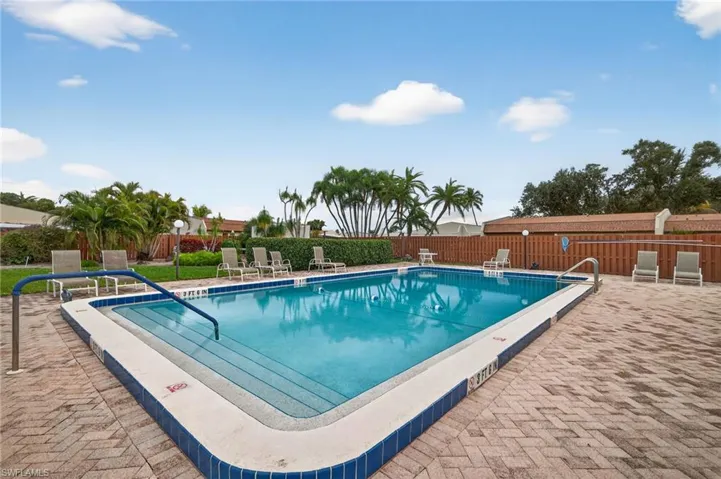 Community pool featuring a patio